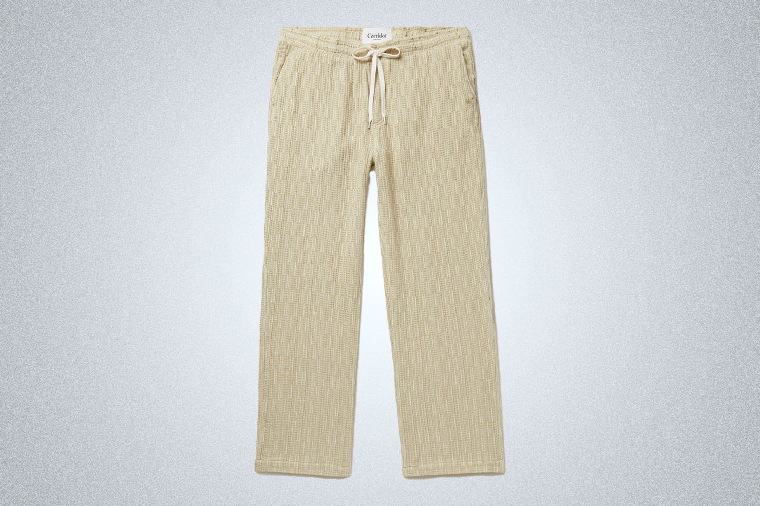 a pair of tan pants from Corridor on a grey background