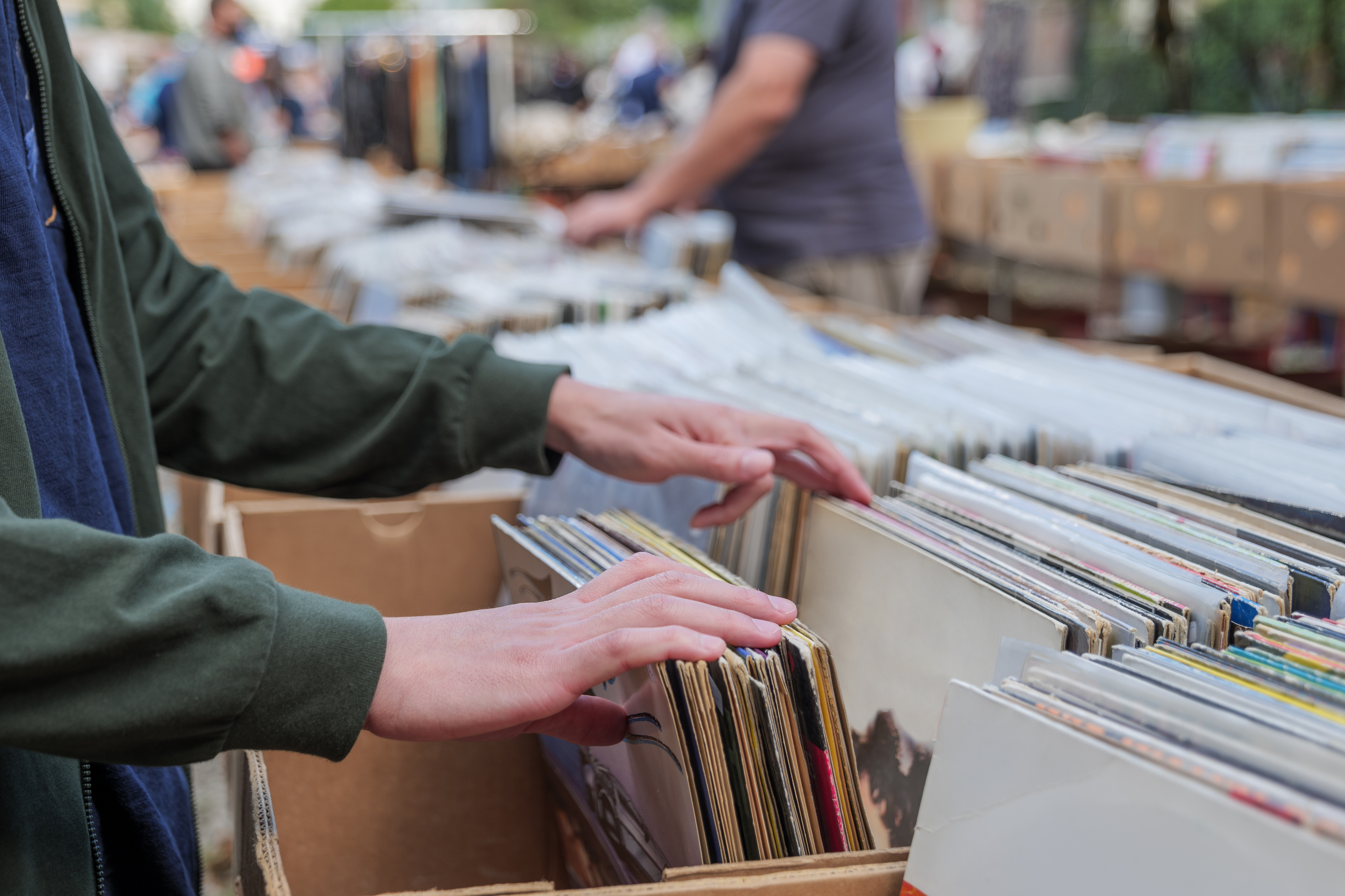A shopper flipping through vinyl records at a record store