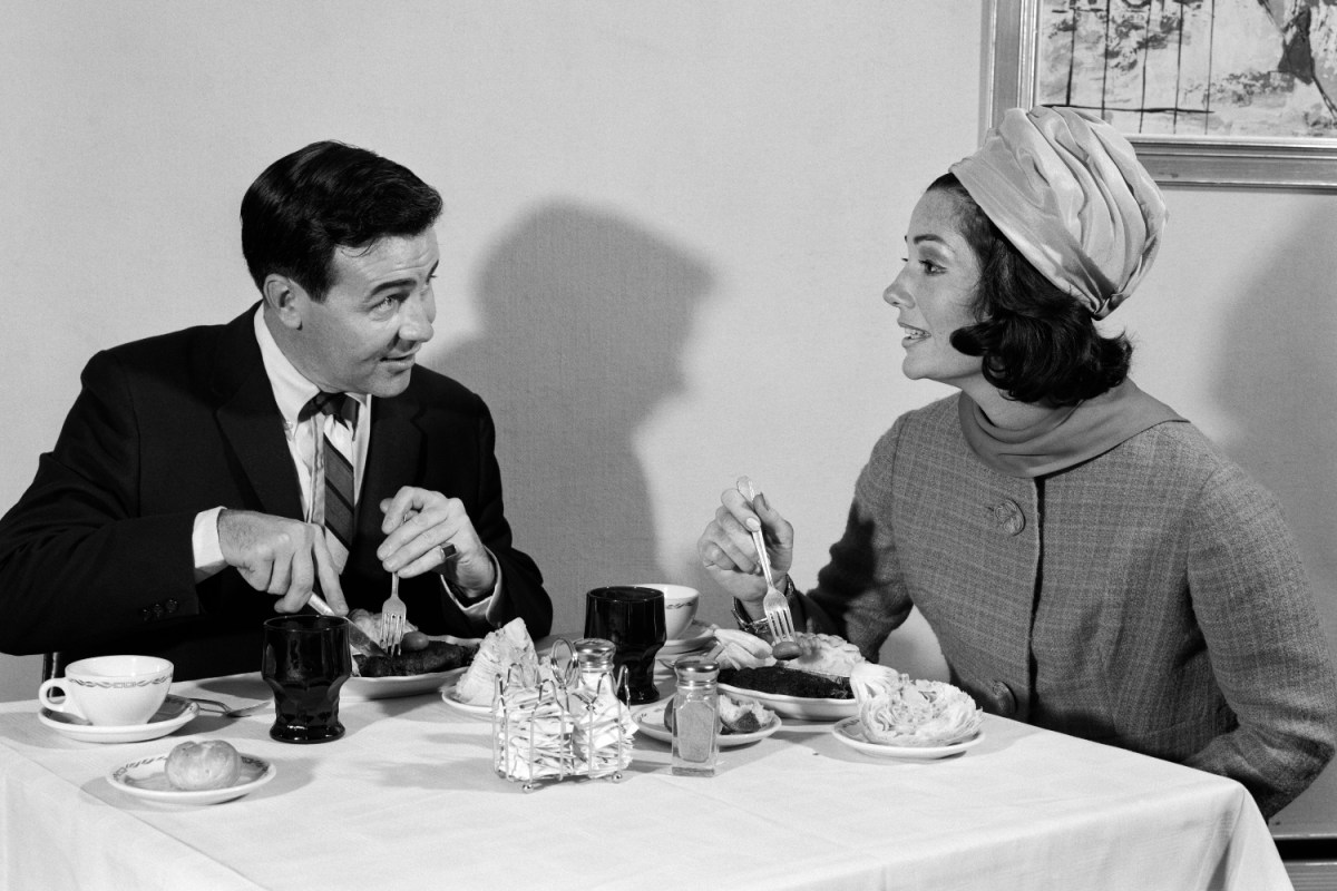Black and white photo shows a couple on a dinner date