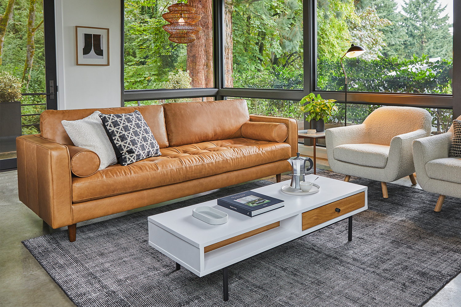 A leather Sven Sofa from Article. The couch is pictured here next to a coffee table and armchair.