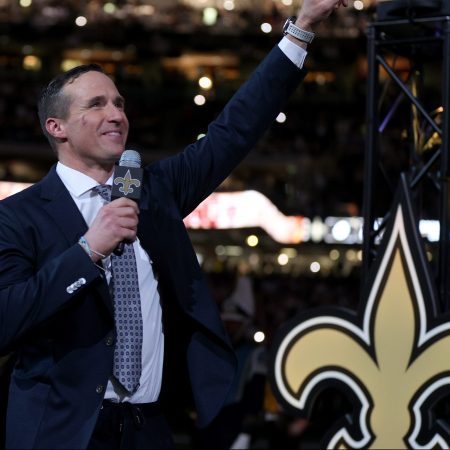 Ex-New Orleans Saints quarterback Drew Brees speaks to fans during halftime of a game. The retired QB was almost coaxed into playing this week due to injuries on the team.