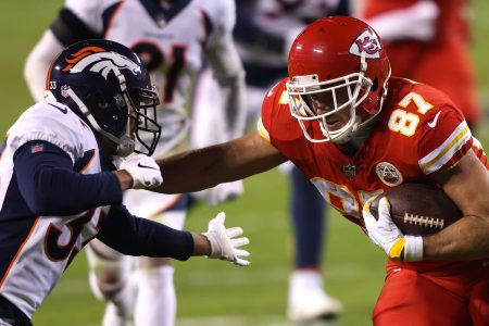 Travis Kelce of the Kansas City Chiefs rushes against the Denver Broncos