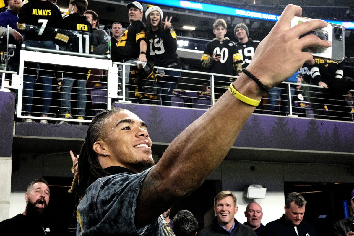 Chase Claypool of the Pittsburgh Steelers takes photos with fans before a game against the Vikings. The WR is being blamed for celebrating during a last-minute drive where Pittsburgh failed to score in time.