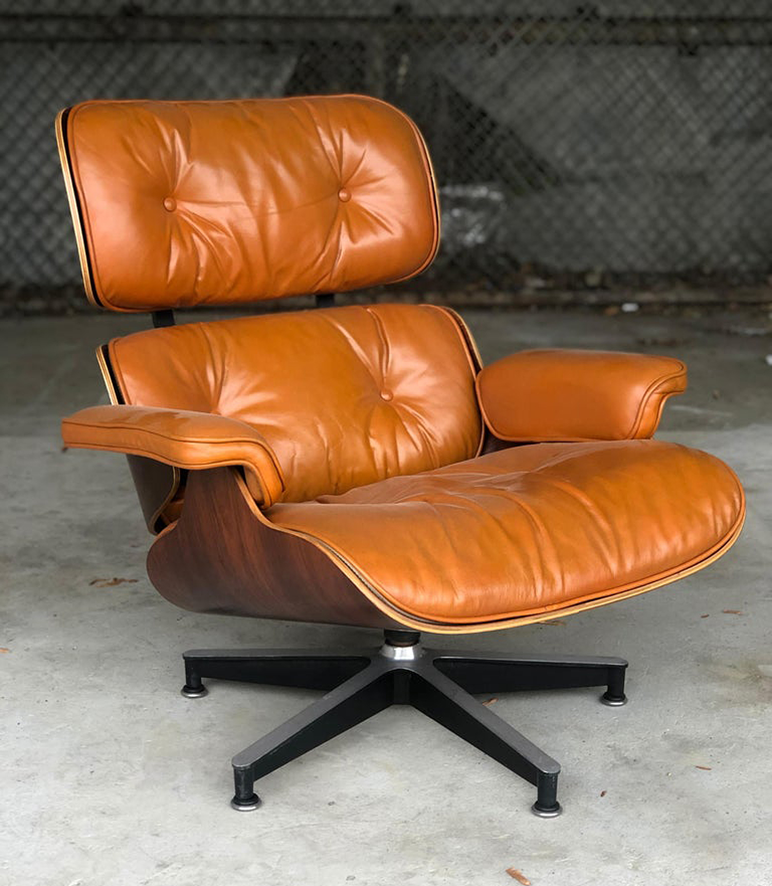An Eames Lounge Chair in burnt orange leather