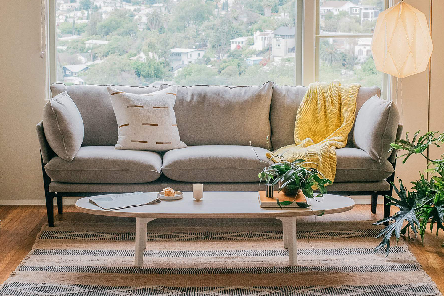 The classic sofa from Floyd sitting next to an oval coffee table in a living room