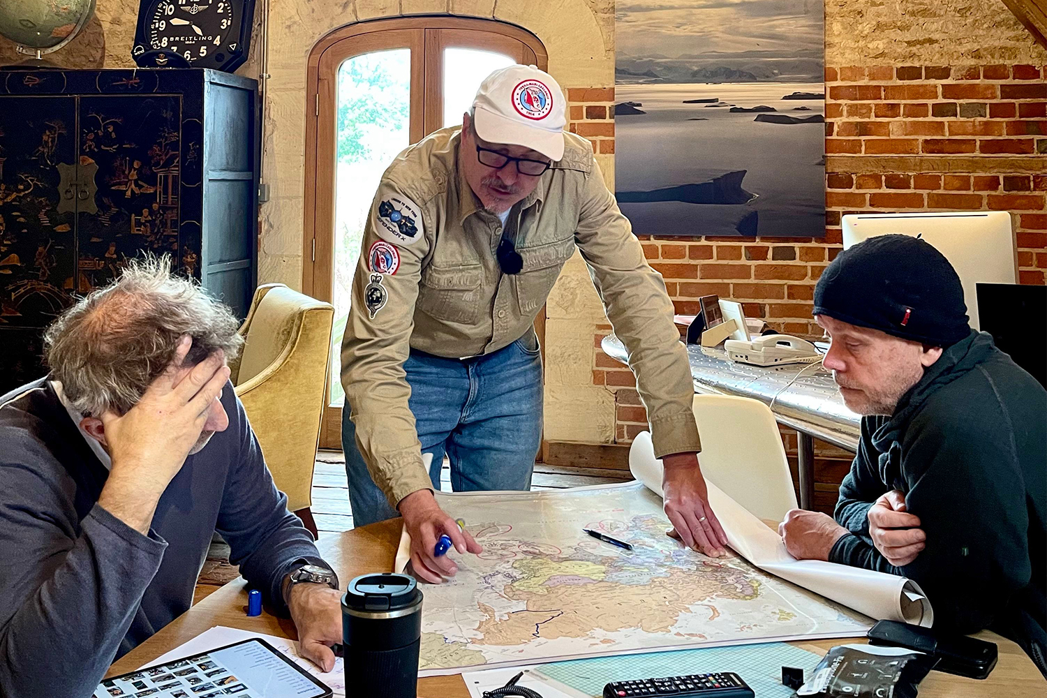 The DefenderX team looking over maps, including Steve Brooks (left), Jeff Willner (center) and Mikael Strandberg (right)