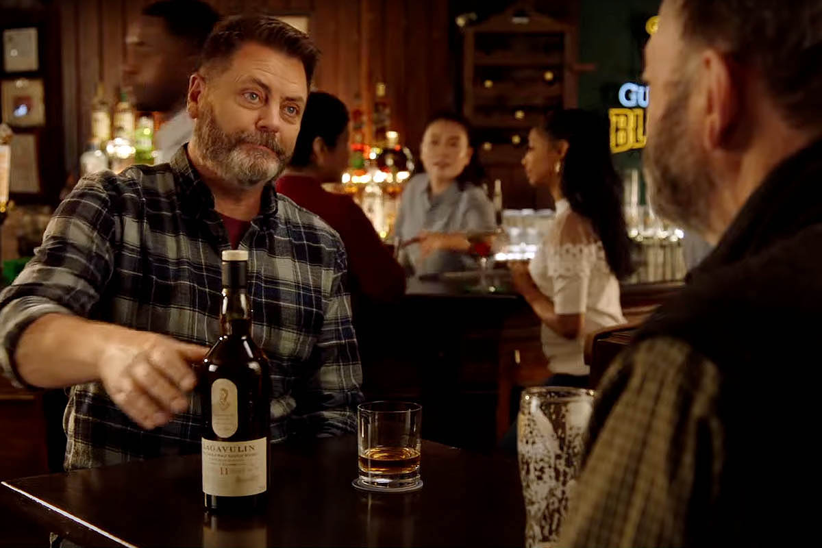 NIck Offerman showing off Lagavulin Offerman Edition: Guinness Cask Finish, which just won Whisky Advocate's Top 20 Whiskies 2021