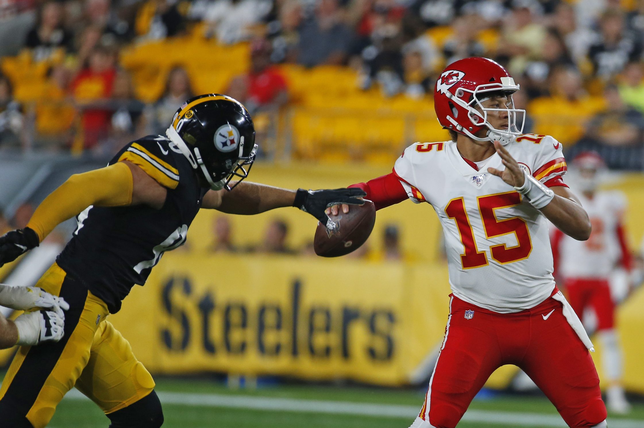 Patrick Mahomes is pressured by T.J. Watt in a preseason game