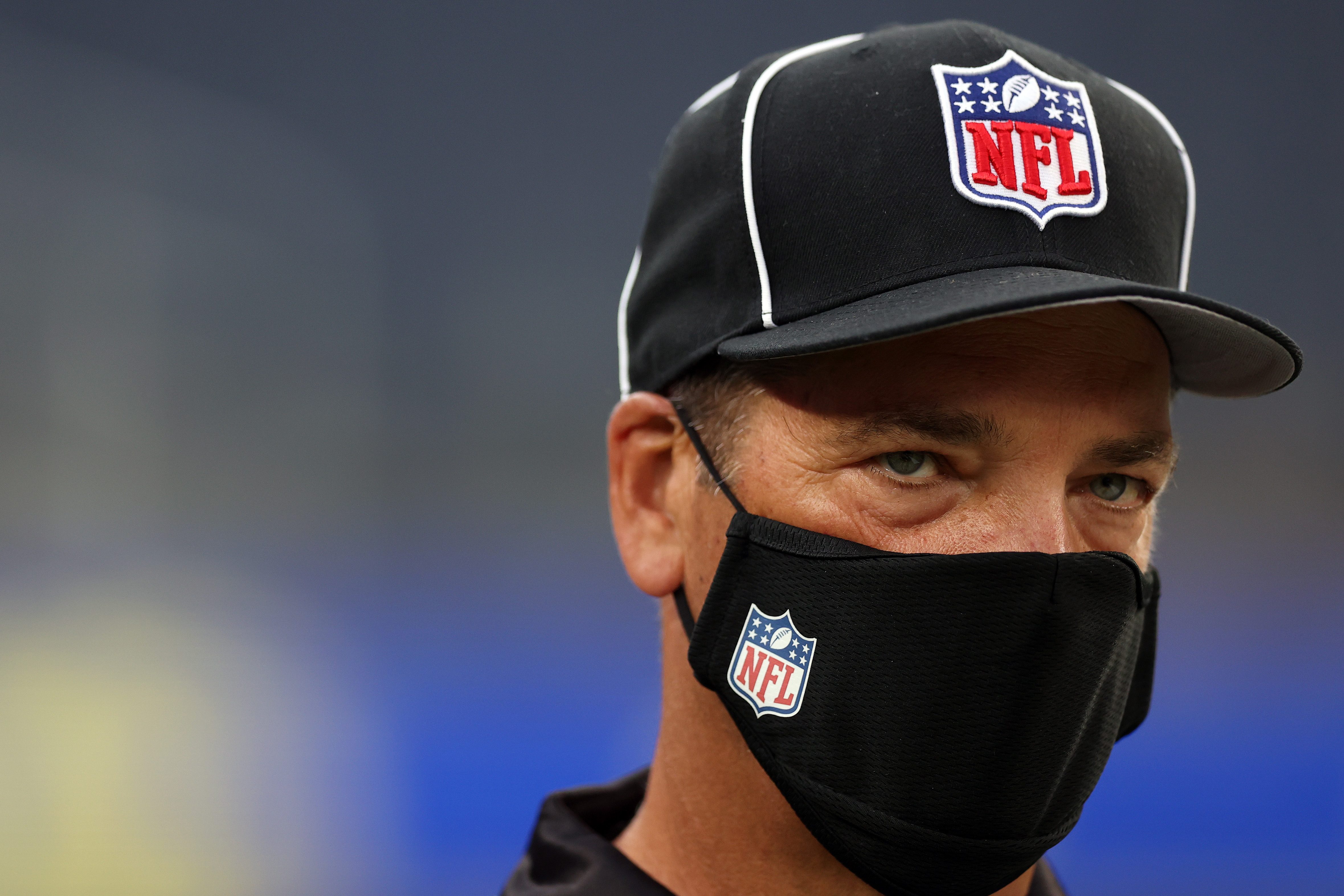NFL side judge David Meslow wears a mask during a preseason NFL game