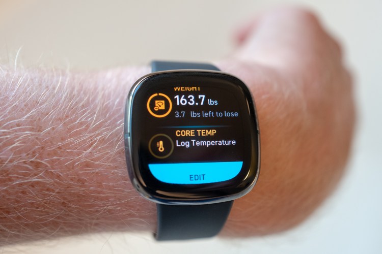 A close-up of fitness tracking watch that says "3.7 pounds left to lose."