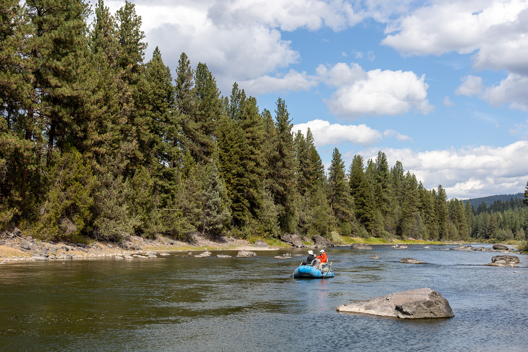 A raft floats the river during an afternoon of fly-fishing at the resort at paws up