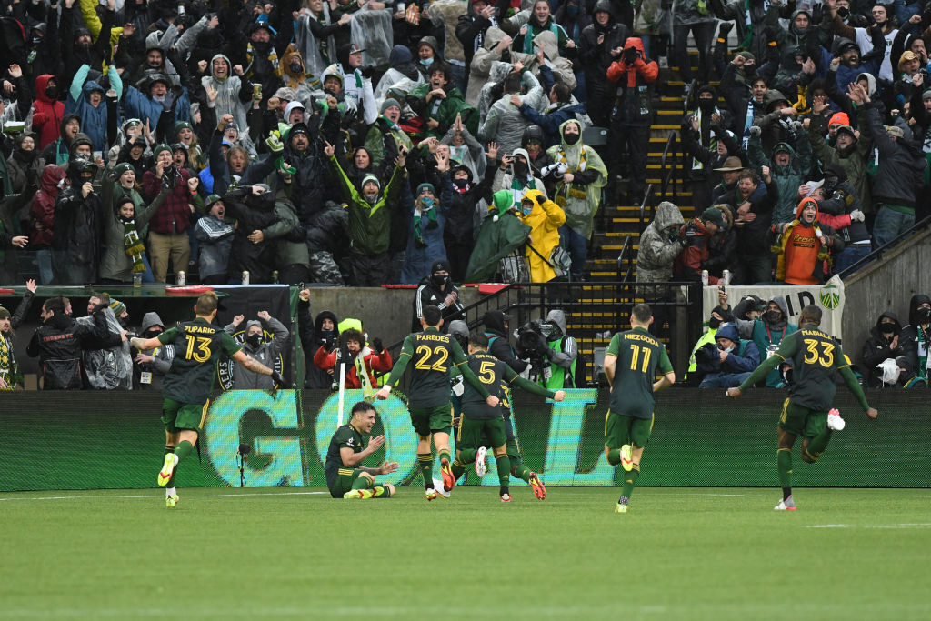 The Portland Timbers react to a game equalizing goal by Portland Timbers forward Felipe Mora, sitting, in stoppage time during the MLS Cup Final between the Portland Timbers and New York City FC.