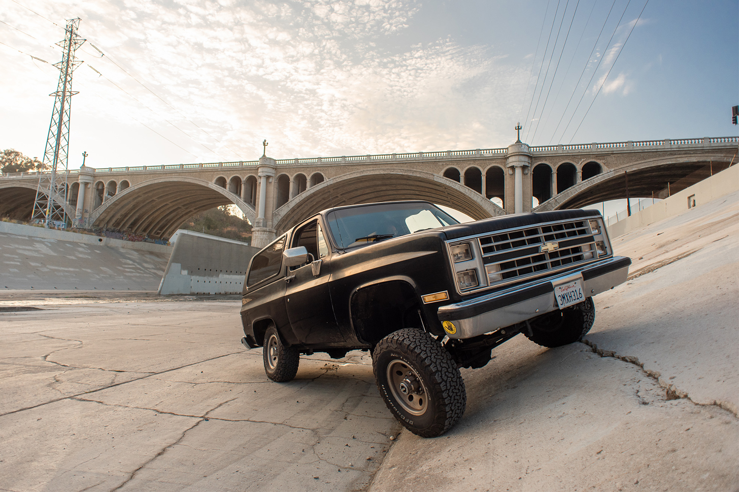 A black 1988 Chevy K5 Blazer Silverado sitting on the bank of the Los Angeles River. The classic SUV was restored by Kyle Cheromcha.