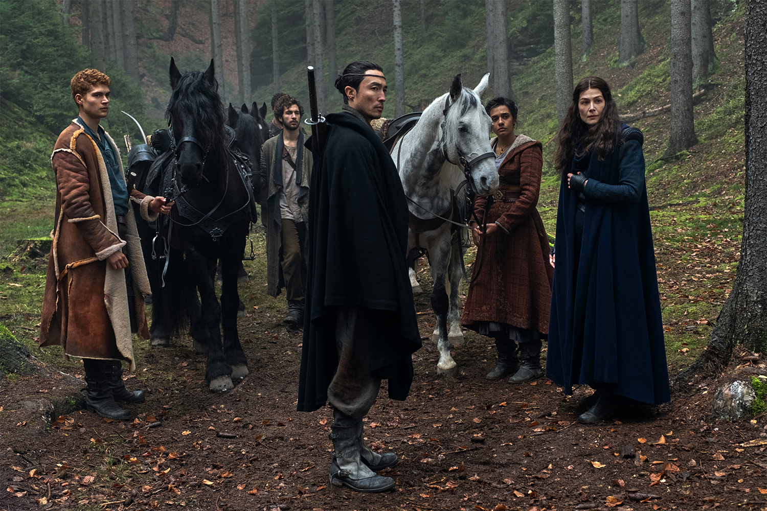 The main characters in the "Wheel of Time" Prime Video series, including Lan, Moiraine, Egwene, Mat and Rand, all standing in the forest in episode two of season one