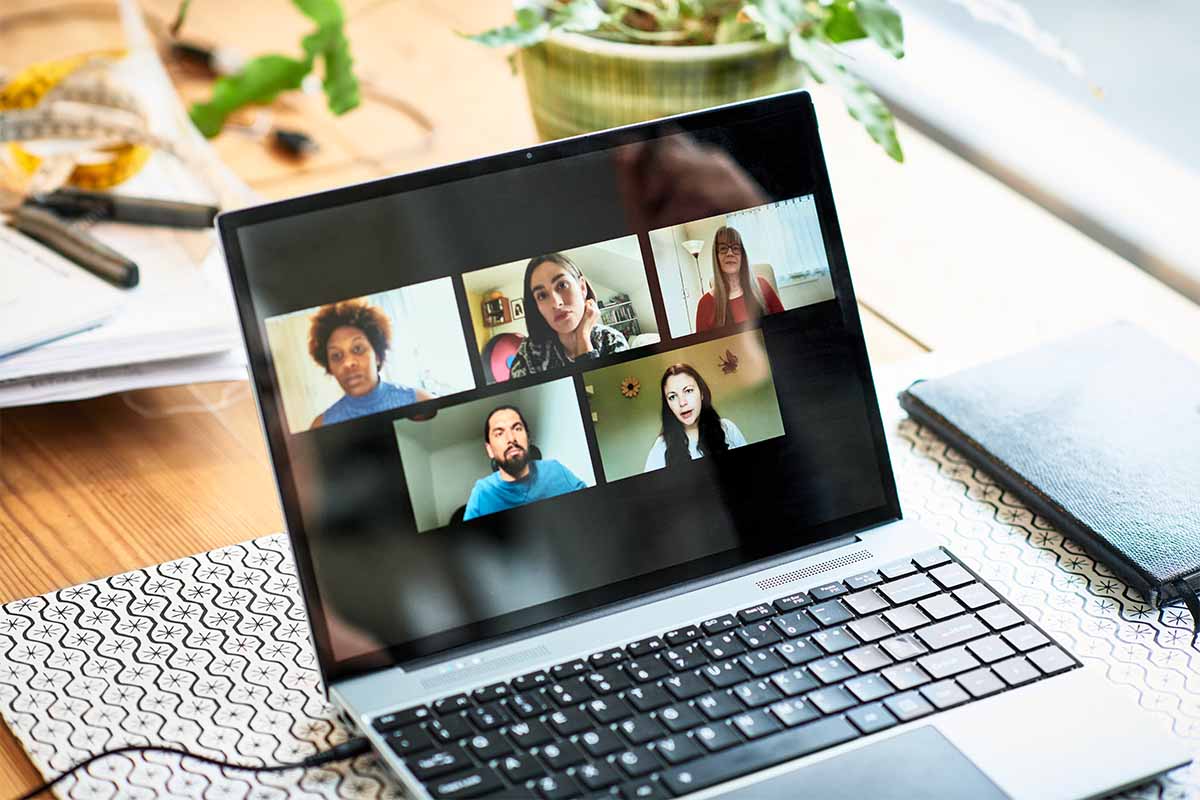 Close up of laptop participants on video conference, virtual team meeting, colleagues. Zoom just settled an $85 million class action lawsuit.