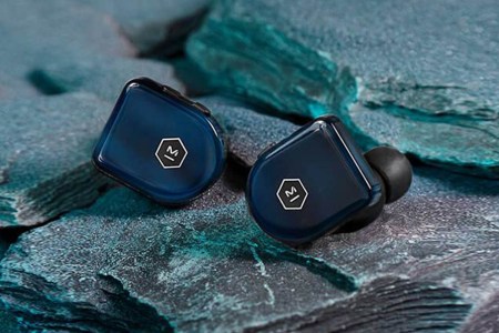 A pair of Master & Dynamic's MW07 Plus earbuds laying outside; the earbuds are currently 40% off.