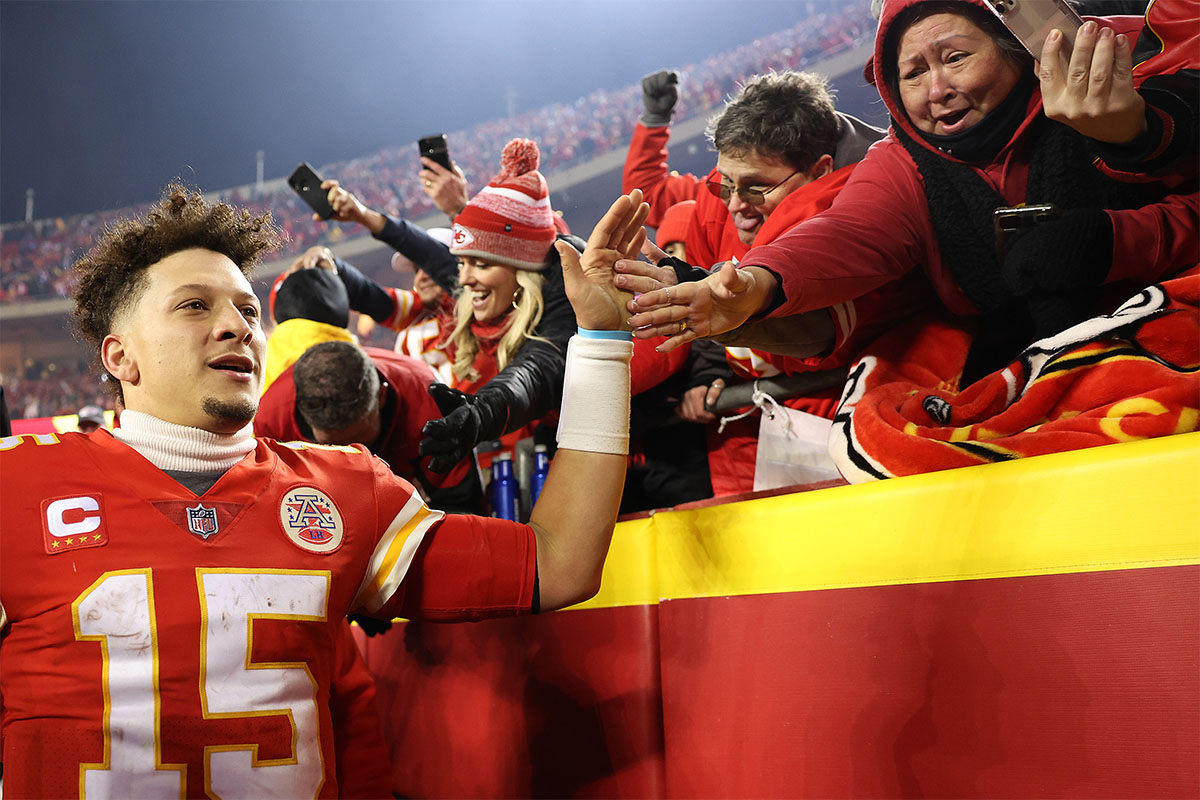Kansas City Chiefs quarterback Patrick Mahomes high-fives fans. Fitness tracker WHOOP recently analyzed the star NFL player's heart rate from January 23, 2022 Bills vs Chiefs playoff game.