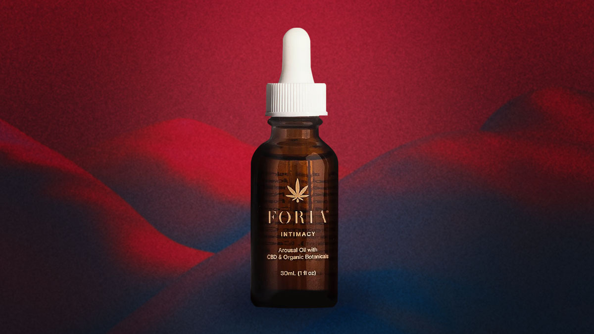 Foria's Awaken Arousal Oil on a red and black background.