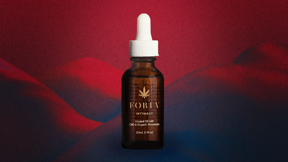 Foria's Awaken Arousal Oil on a red and black background.