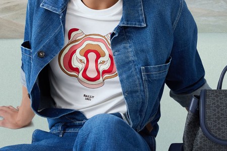 a shirt with a red colored tiger under a denim jacket and pants
