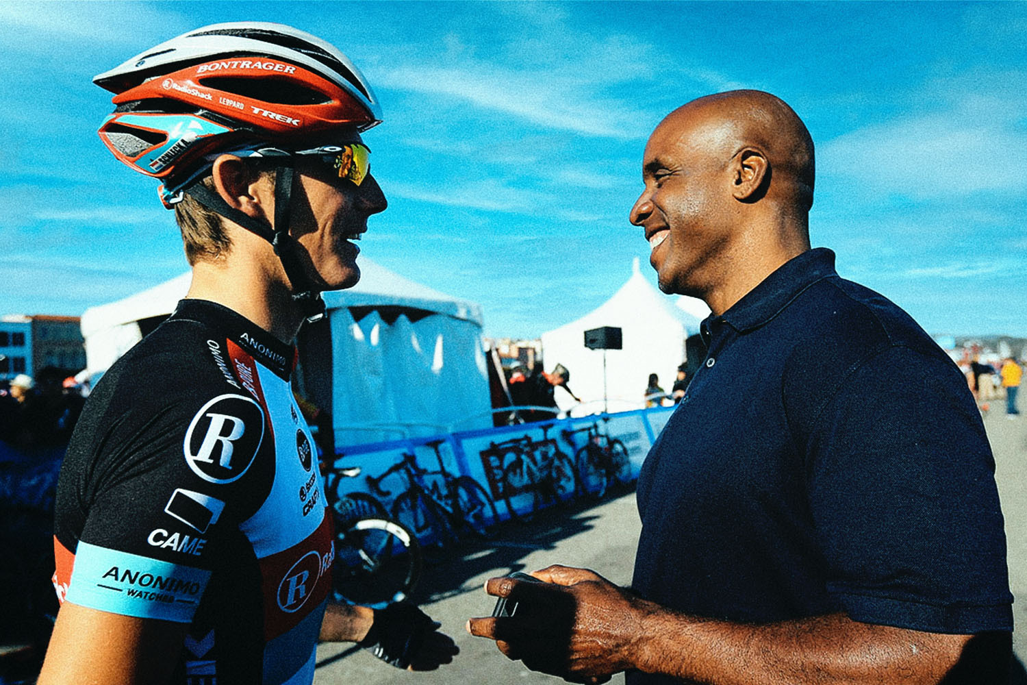 Barry Bonds talking to a cyclist.