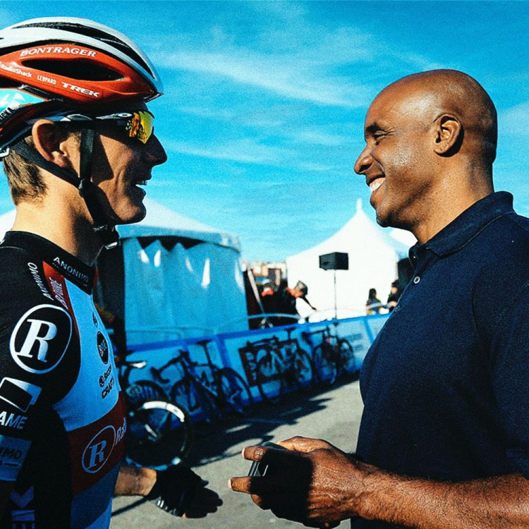 Barry Bonds talking to a cyclist.