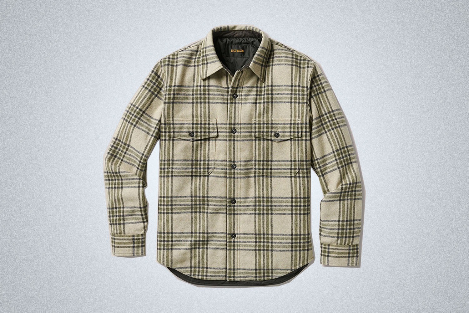a Cchecked white overshirt from Buck Mason on a grey background