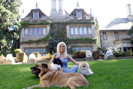 Holly Madison poses with dogs outside the Playboy mansion
