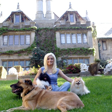 Holly Madison poses with dogs outside the Playboy mansion