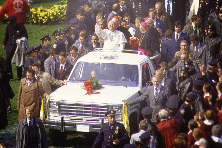 Pope John Paul II arriving at Shea Stadium in New York, New York on October 3, 1979 standing in the truck bed of a 1980 Ford Bronco the automaker converted into a white popemobile