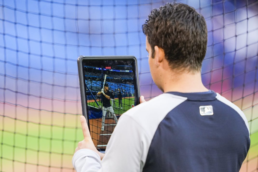 An Apple iPad is used to record Aaron Judge of the Yankees taking batting practice. Apple and MLB have been holding talks to host mid-week games on Apple's streaming service.