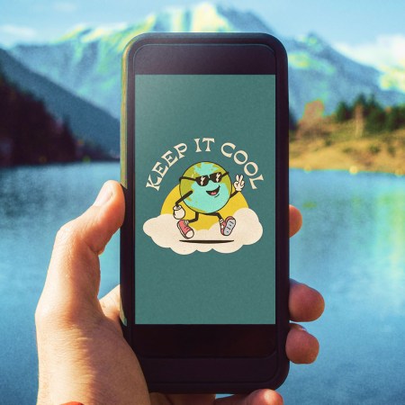 A person holding a smartphone up with a lake and mountain in the background. On the phone is United By Blue's NFT of Eddy Earth, the sustainable brand's new mascot.