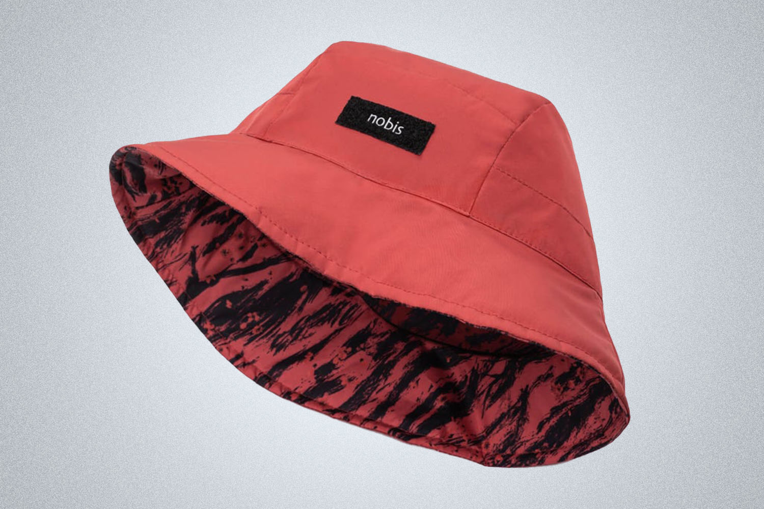 a reversible bucket hat with a plain red side and a red tiger print
