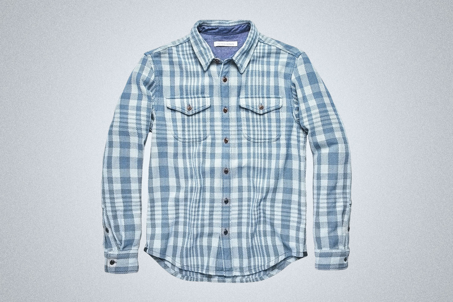 a plaid blue checked Outerknown Blanket Shirt on a grey background