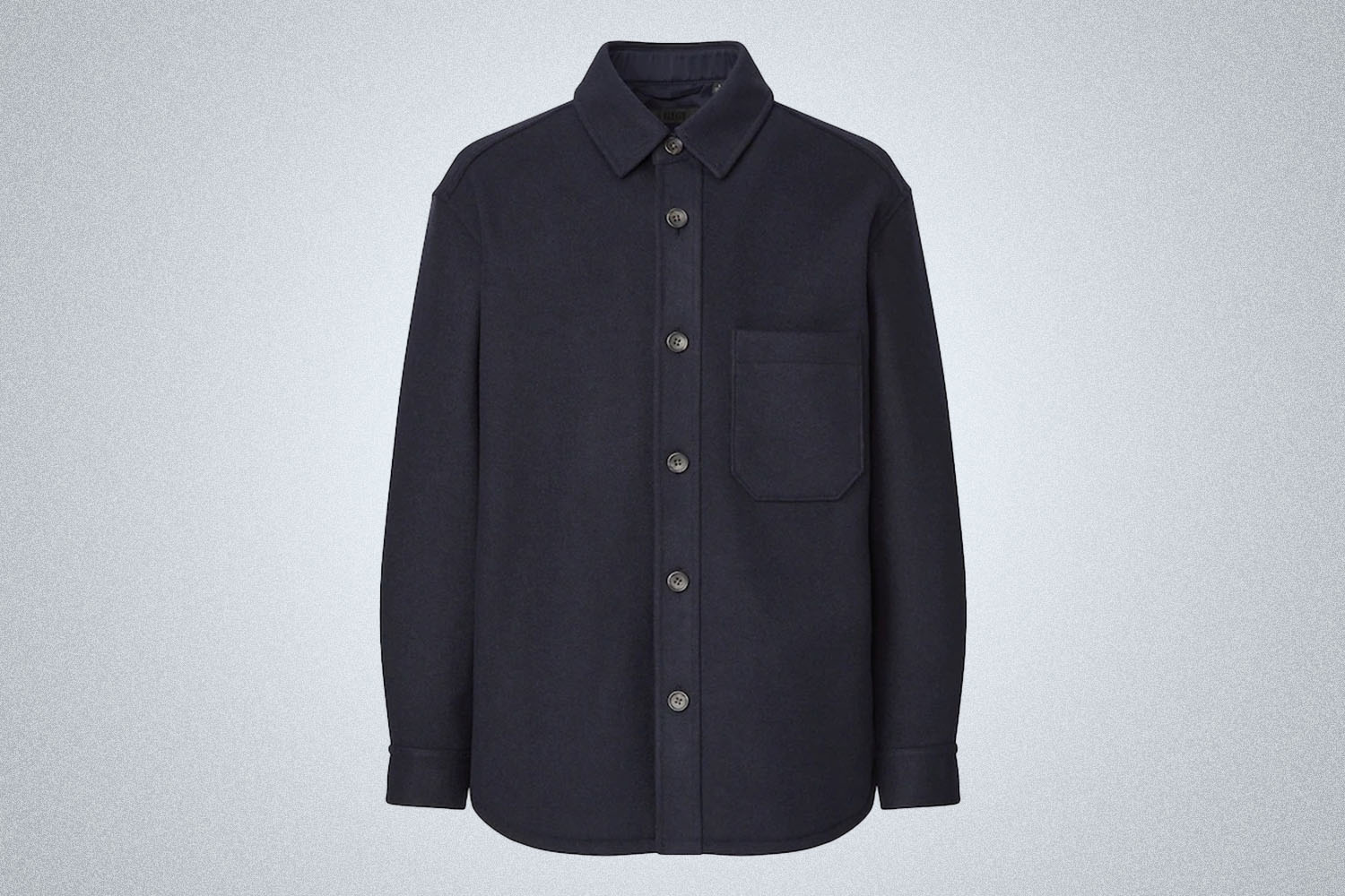 a navy blue buttoned overshirt from Uniqlo on a grey background