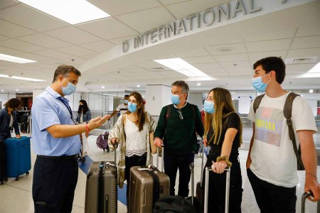 A worker informs about free Johnson & Johnson vaccines against Covid-19 at the International arrivals concourse of Miami International Airport, in Miami, Florida, on May 29, 2021. Several countries have been added to the CDC's "Avoid Travel" list for Covid-19.