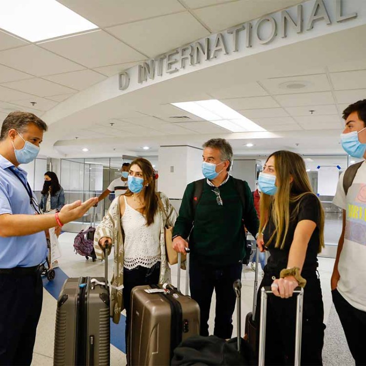 A worker informs about free Johnson & Johnson vaccines against Covid-19 at the International arrivals concourse of Miami International Airport, in Miami, Florida, on May 29, 2021. Several countries have been added to the CDC's "Avoid Travel" list for Covid-19.
