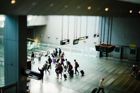 A group of people with luggage at an airport. The Transportation Security Administration says a record number of people tried bringing guns on planes in 2021.