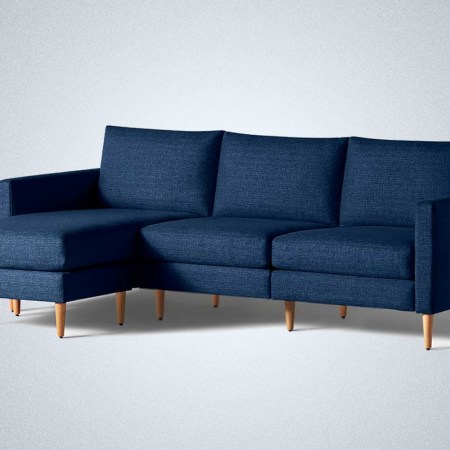 An Allform couch in navy blue with an extended chaise