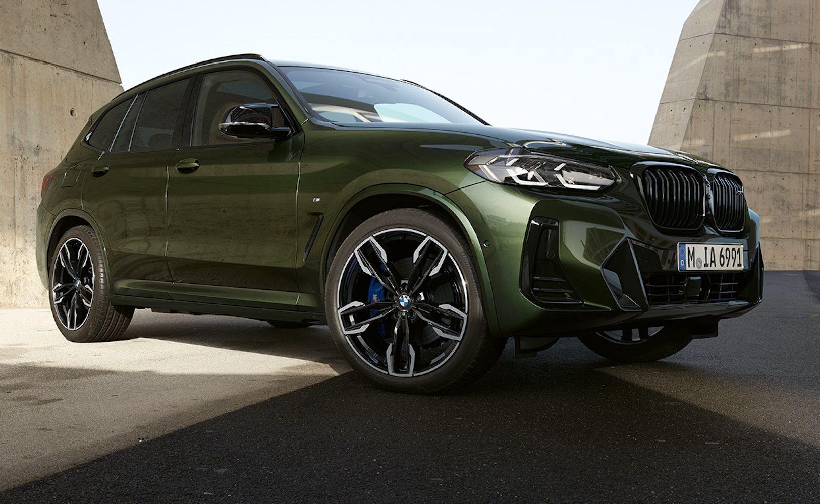 A look at the side of the 2022 BMW X3 M40i SUV in green. Read about our test drive in this full review of the luxury vehicle.