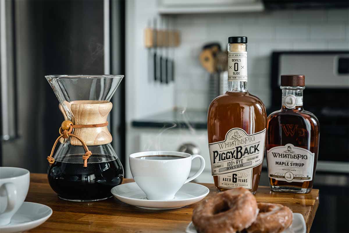 Coffee and a donut with a bottle of WhistlePig Devil's Slide