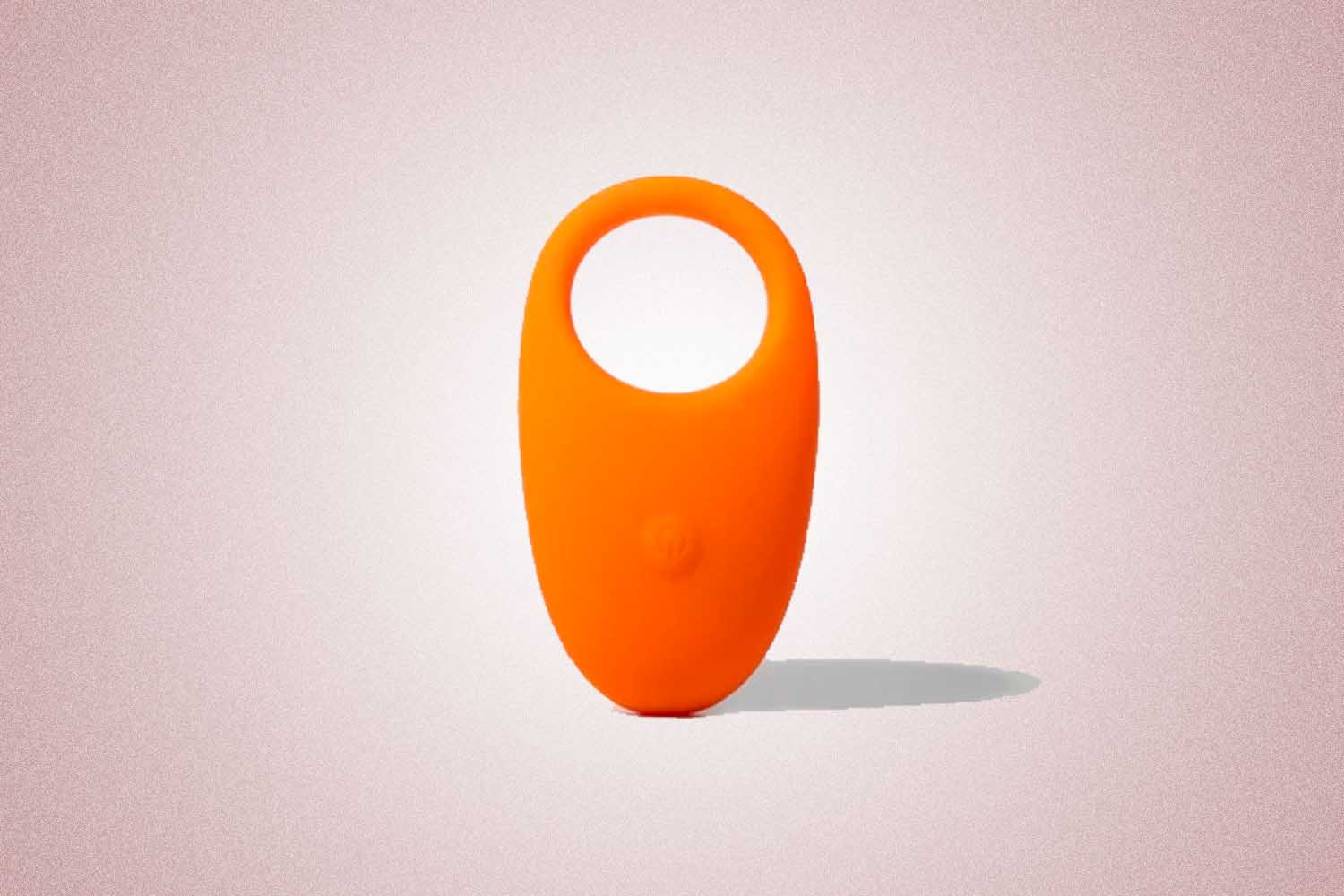 An orange vibrating penis ring, a perfect Valentine's Day gift, on a pink background. 