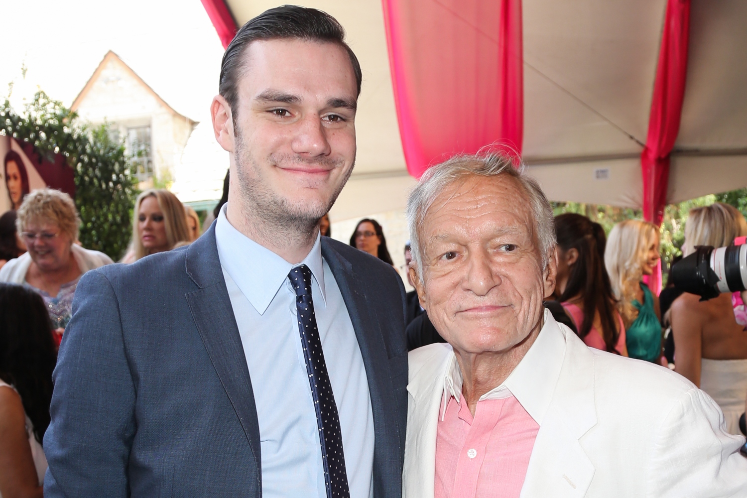 Playboy Founder Hugh Hefner (R) and and his son Cooper Hefner (L) attend the 2013 Playmate Of The Year announcement at The Playboy Mansion on May 9, 2013 in Beverly Hills, California.