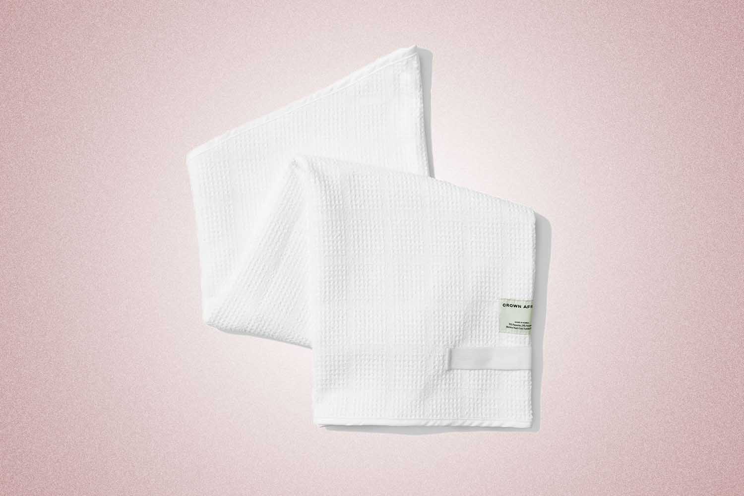 A white hair towel cami from Crown Affair, a perfect Valentine’s Day gift for 2022, on a pink background.