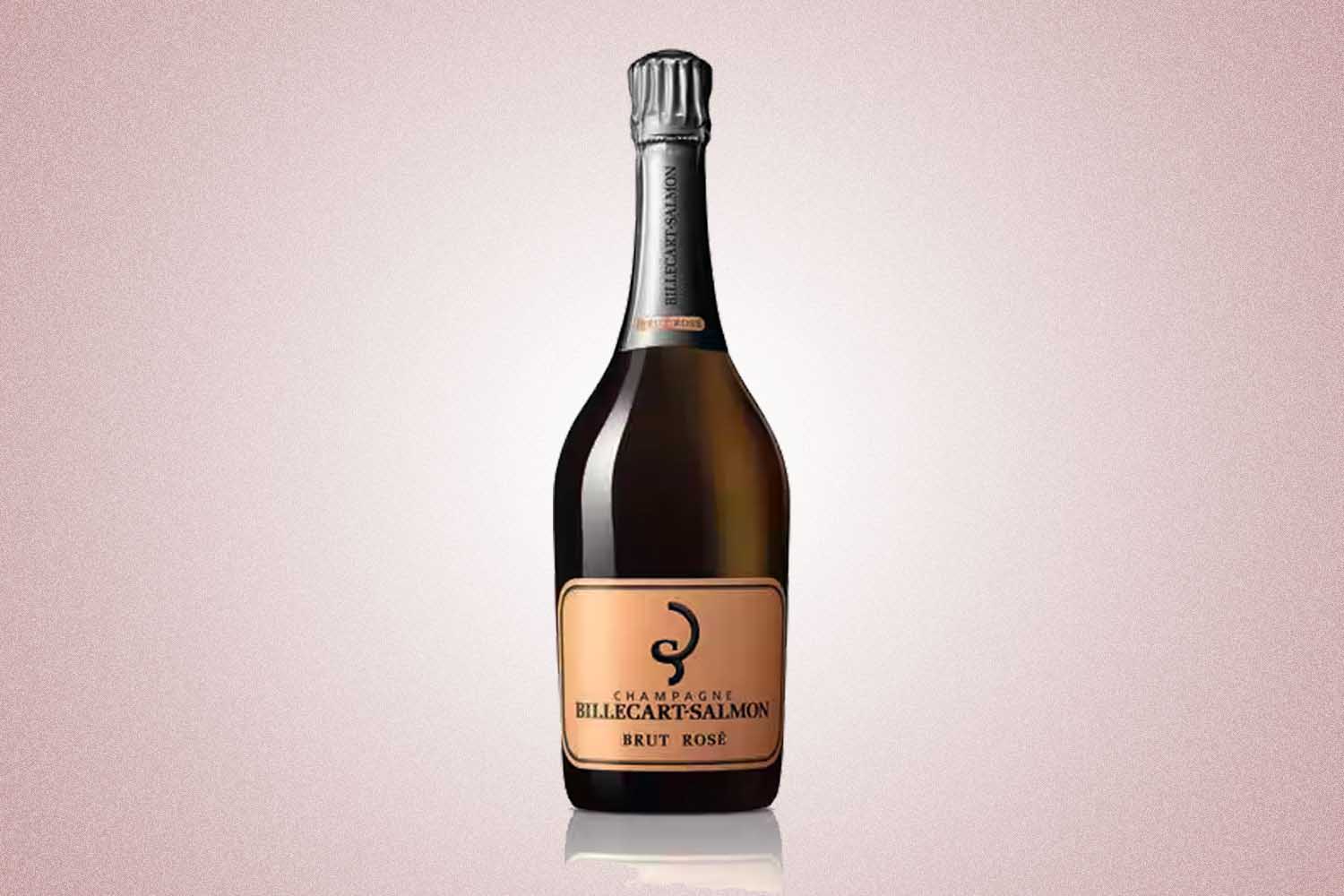 A bottle of Billecart-Salmon Brut Rose with grey foil at the top and a rose gold colored label, a perfect Valentine’s Day gift for 2022, on a pink background.