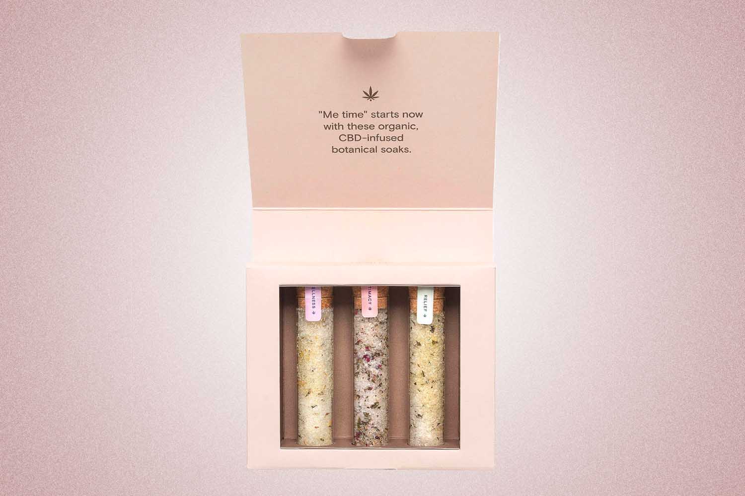 A trio of CBD bathsalts from Foria, a perfect Valentine’s Day gift for 2022, on a pink background.