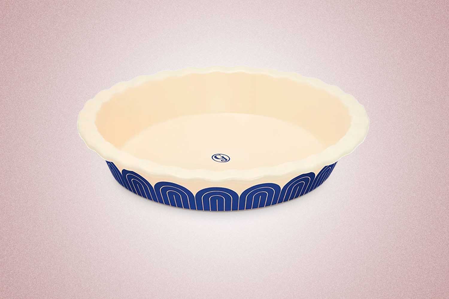 A blue and white pie dish from Great Jones, a perfect Valentine’s Day gift for 2022, on a pink background.