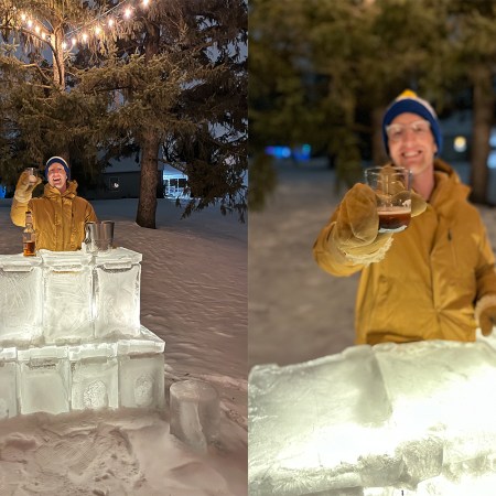 A man standing behind an ice bar in the backyard of a suburban home holding a cocktail. We describe how to make your own ice bar in this advice column.