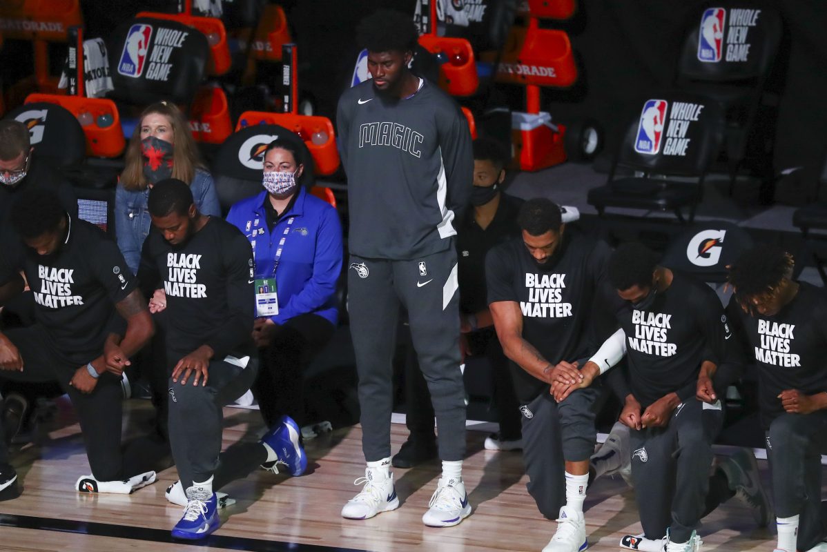 Jonathan Isaac stands during the national anthem before an NBA game. Isaac is releasing a new book through Ben Shapiro's publishing house.