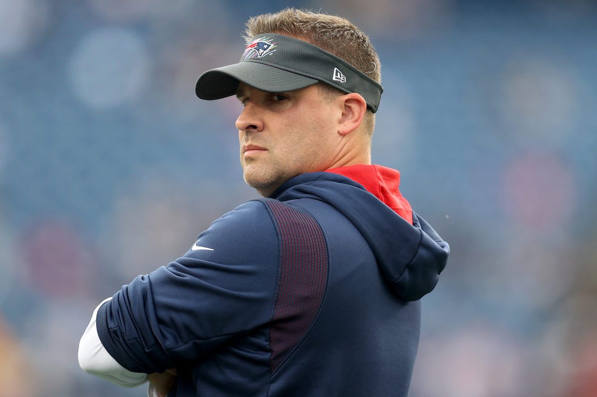 Josh McDaniels stands on the field before a game against the Dallas Cowboys at Gillette Stadium